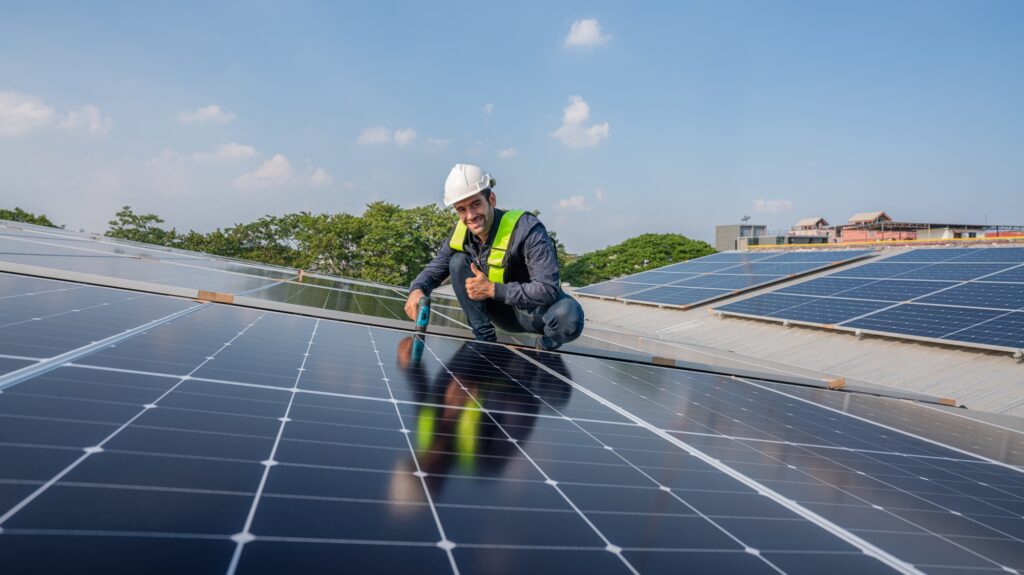 Engineer service check installation solar cell on the roof of factory.